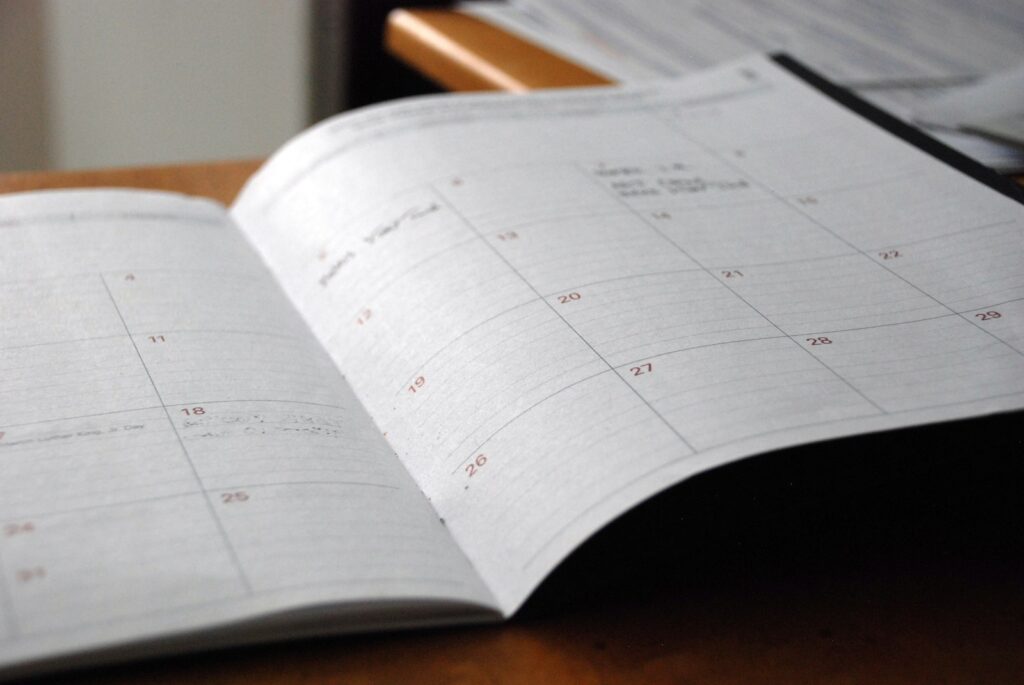 Planejamento de 13º e férias de sócio de empresa em agenda mensal sobre mesa de escritório